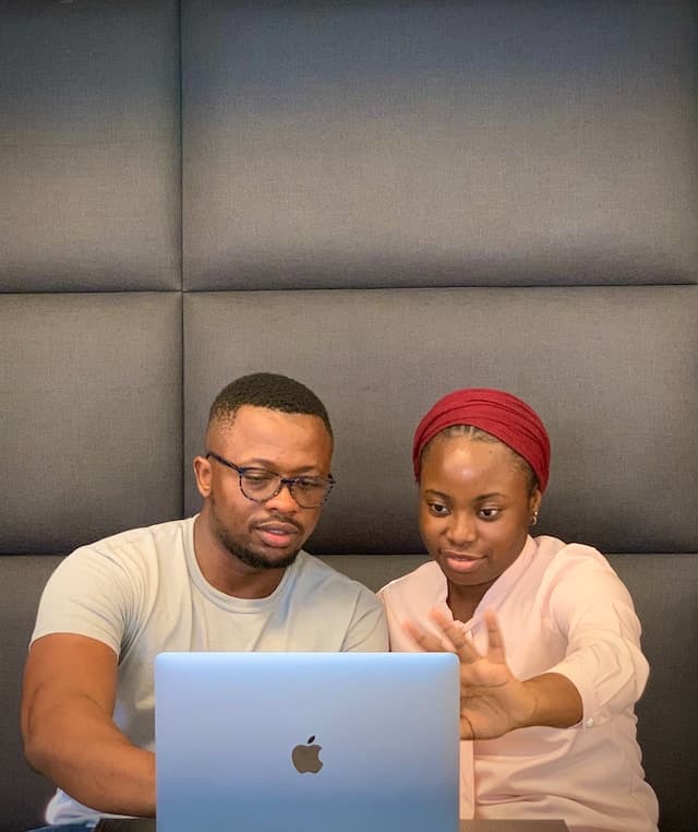 Two people looking at laptop